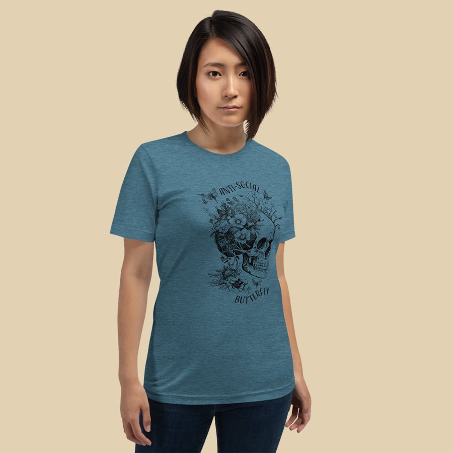 Anti-Social Butterfly Shirt is a t-shirt for book lovers that comes in multiple colors and has a skull growing with flowers, butterflies, and fairies.
