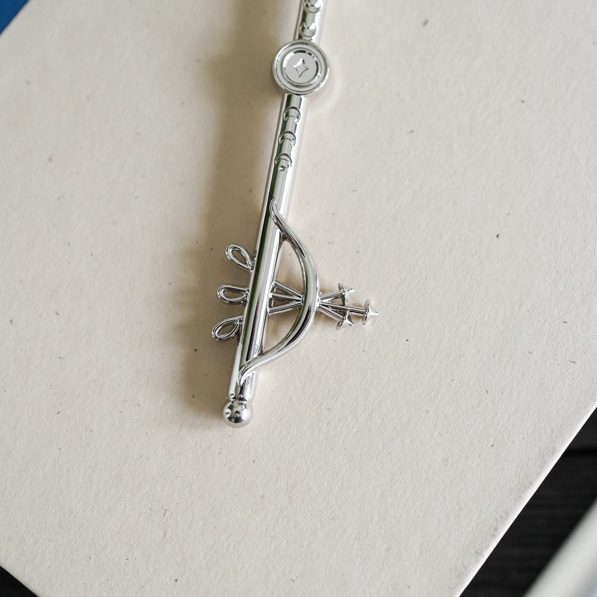 Silver Artemis Greek Mythology Key has a bow and arrow, crescent moons, antlers, and a bee.