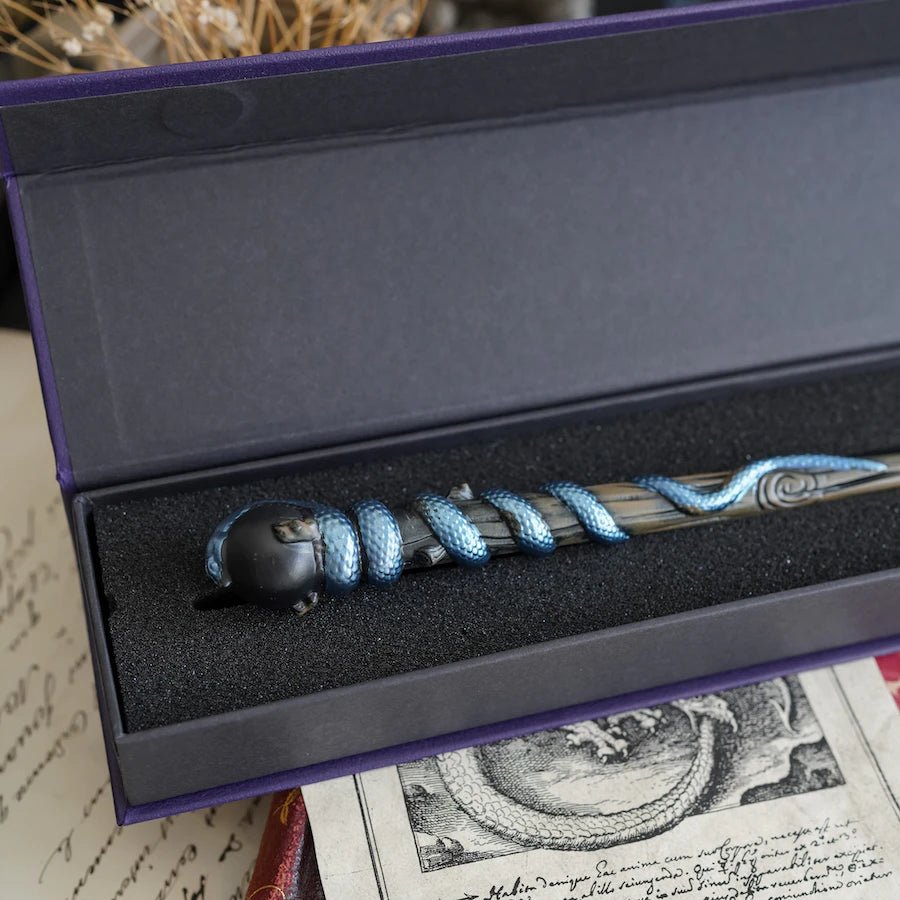 Snake Wand is a black wand with a shimmery blue snake surrounding the top and in a wand box