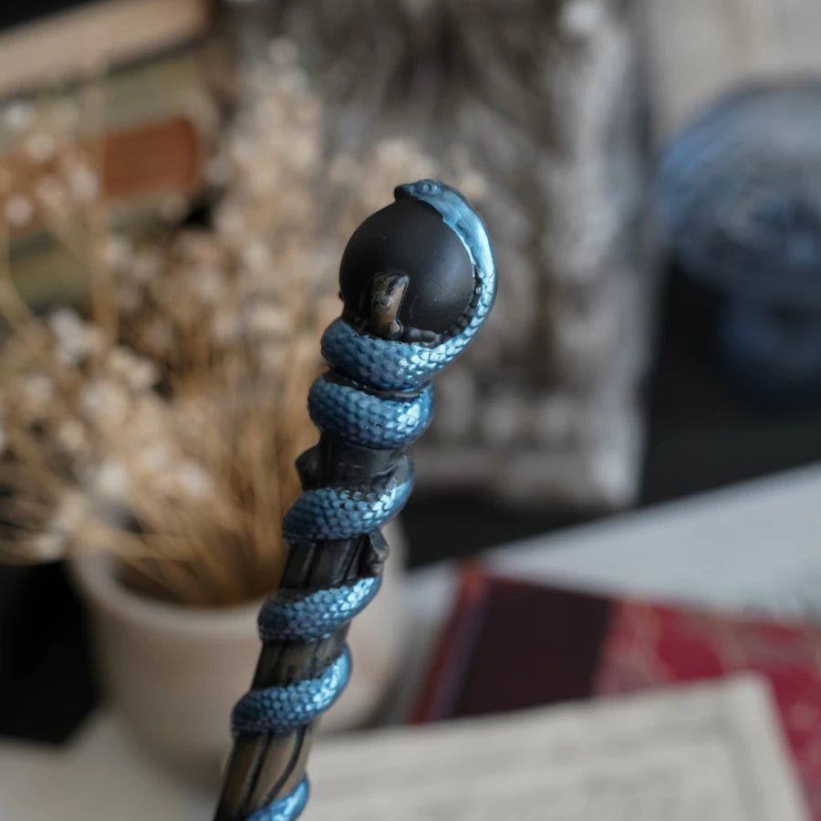 Snake Wand to witches and wizards is black with blue shimmery snake wrapped around it