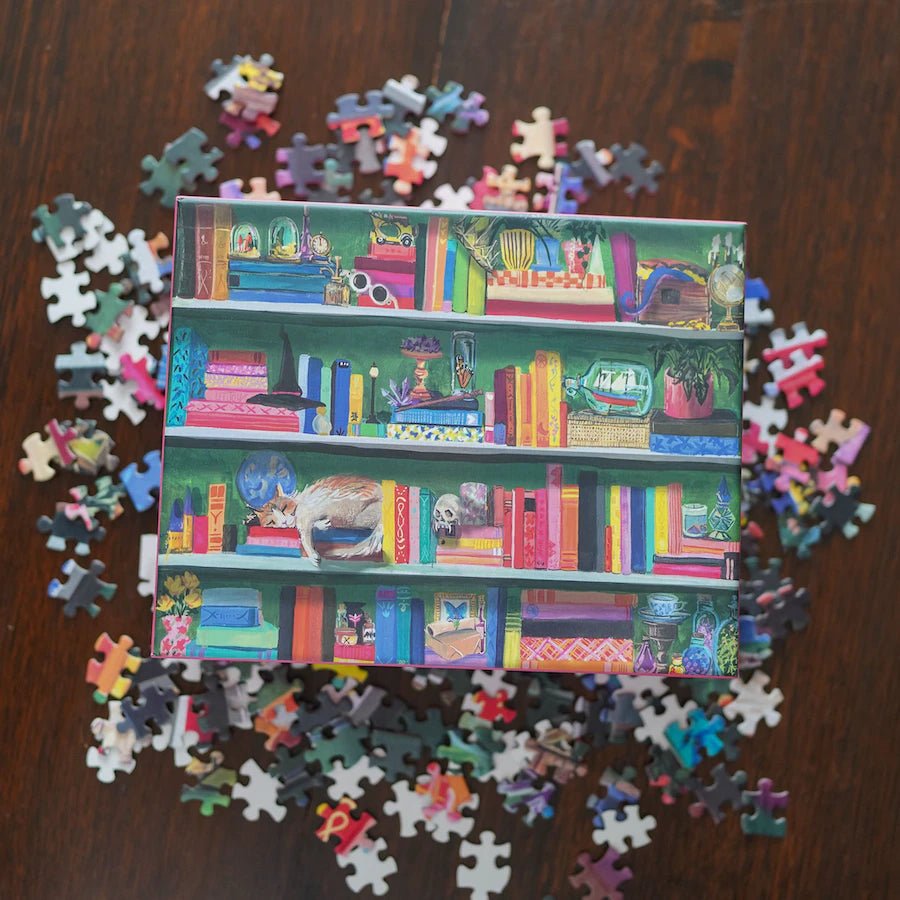 Bookshelf Jigsaw Puzzle featuring a full bookshelf of popular book titles illustrated with plants, globes, and other obscure items.