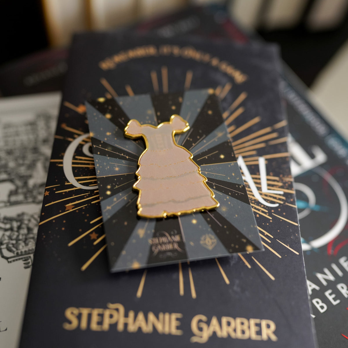 Caraval Lenticular Dress Pin has a gold edge and changes from white to a deep red dress with ruffles and black detailing.