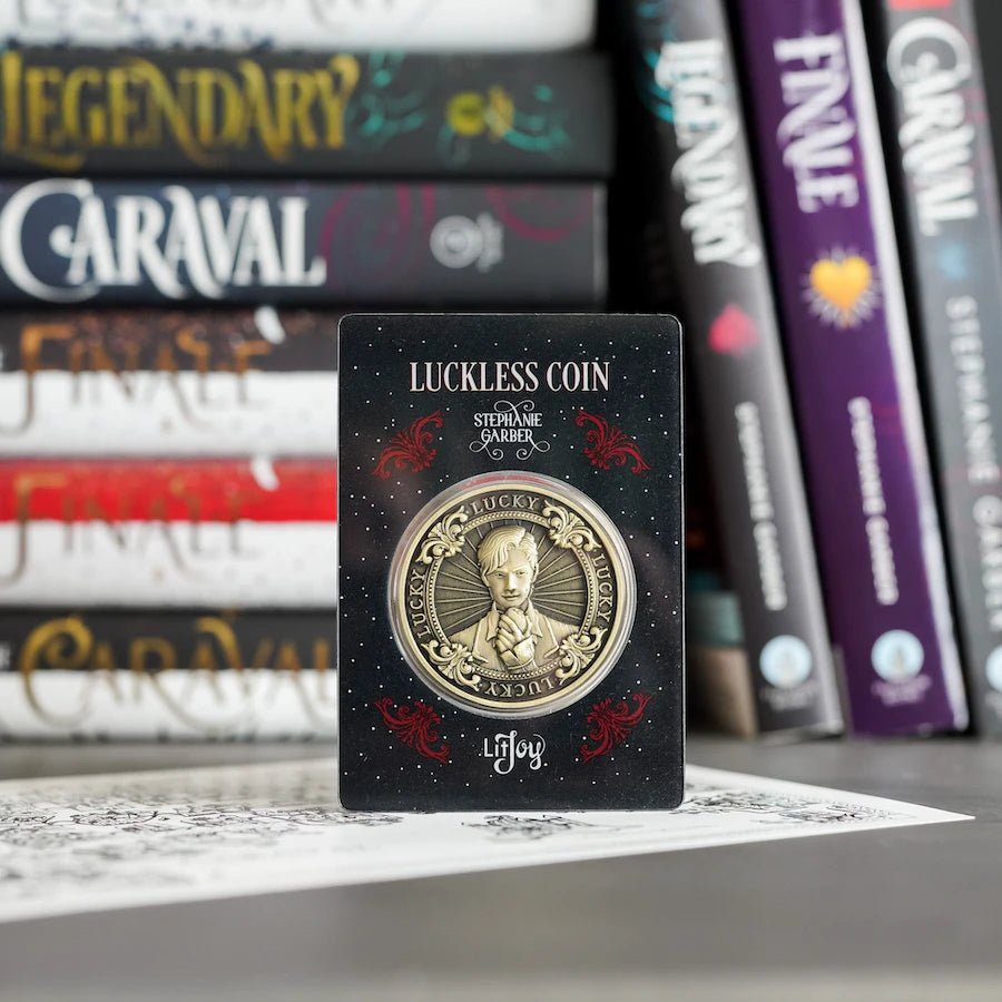 Caraval Luckless Literary Coin is metal with an antique gold finish. Two sides with Jacks and &quot;Lucky&quot; and &quot;Luckless&quot; on opposite sides.