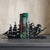 Matte black bookends featuring a fearsome ship on one end and a mesmerizing siren emerging from the ocean on the other.