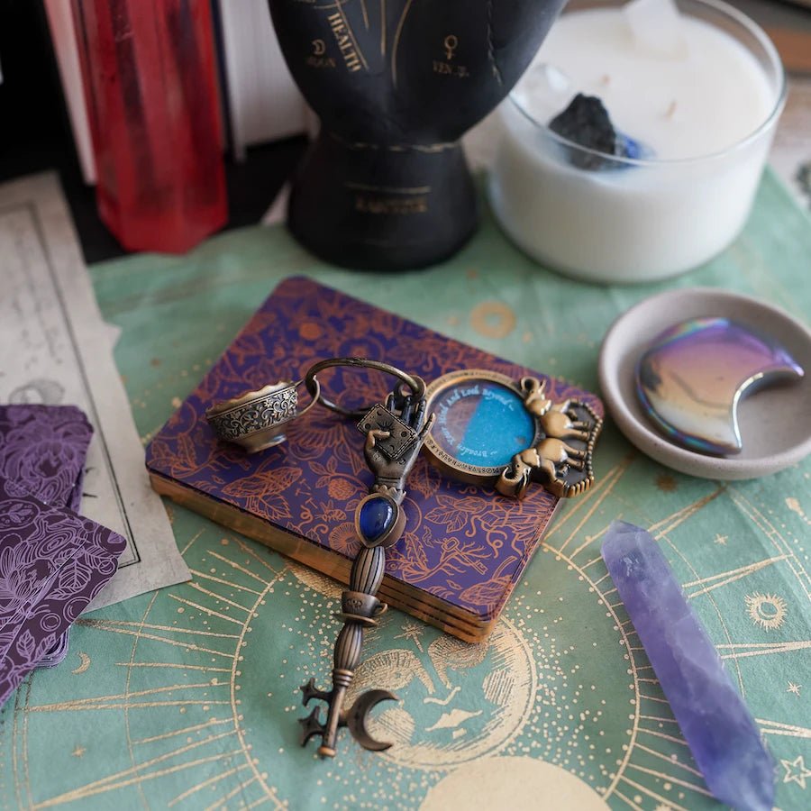 Golden Divination Key with a hand holding a card and a moon/stars on the bit. Comes with mini metal teacup and crystal ball charms.