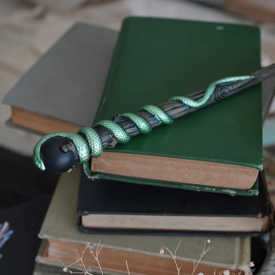 This Green Snake Wand is a black wand with green serpent twirling around the top half of the core.