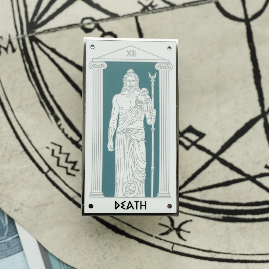 Hades Death Mythology Tarot Enamel Pin shows Hades on a grey background with skulls on his shoulder and holding his sceptre.
