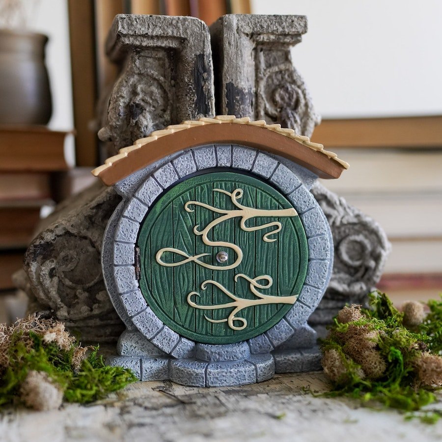 Halfling Fairy Door opening with images of a cozy home full of books and furniture