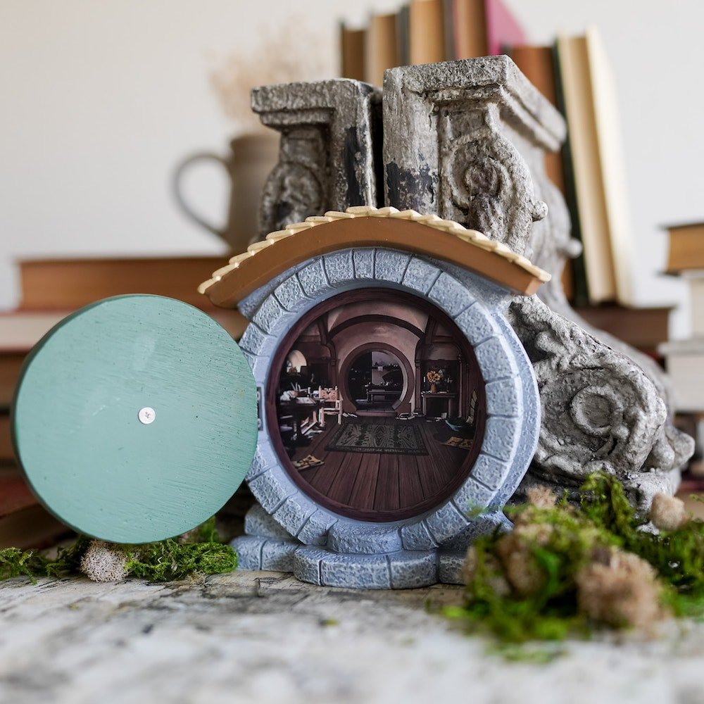 Halfling Fairy Door opening with images of a cozy home full of books and furniture