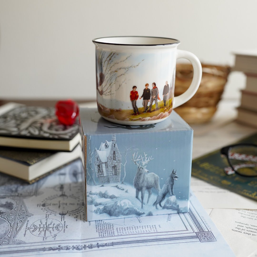 Haunted Shack Mug is white with a black rim and artwork of 4 wizard friends and a willow tree
