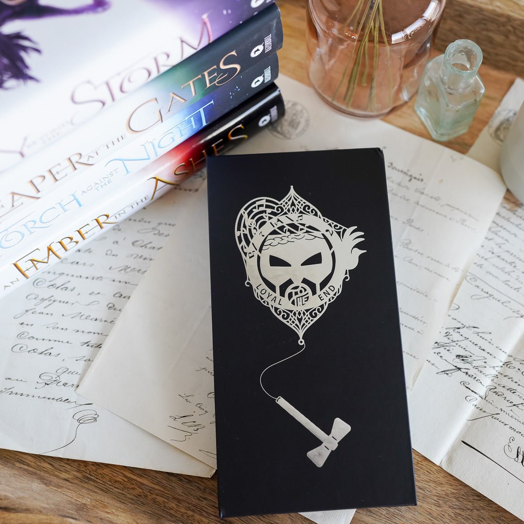 Helene Metal Mask Bookmark says "Loyal to the End" on a metal cut out mask and a hanging hammer