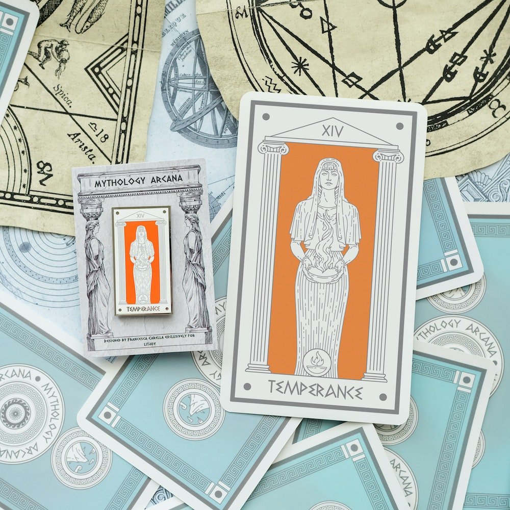 On the Hestia Temperance, Mythology Tarot Enamel Pin, Hestia holds a cup of fire in front of an orange background.
