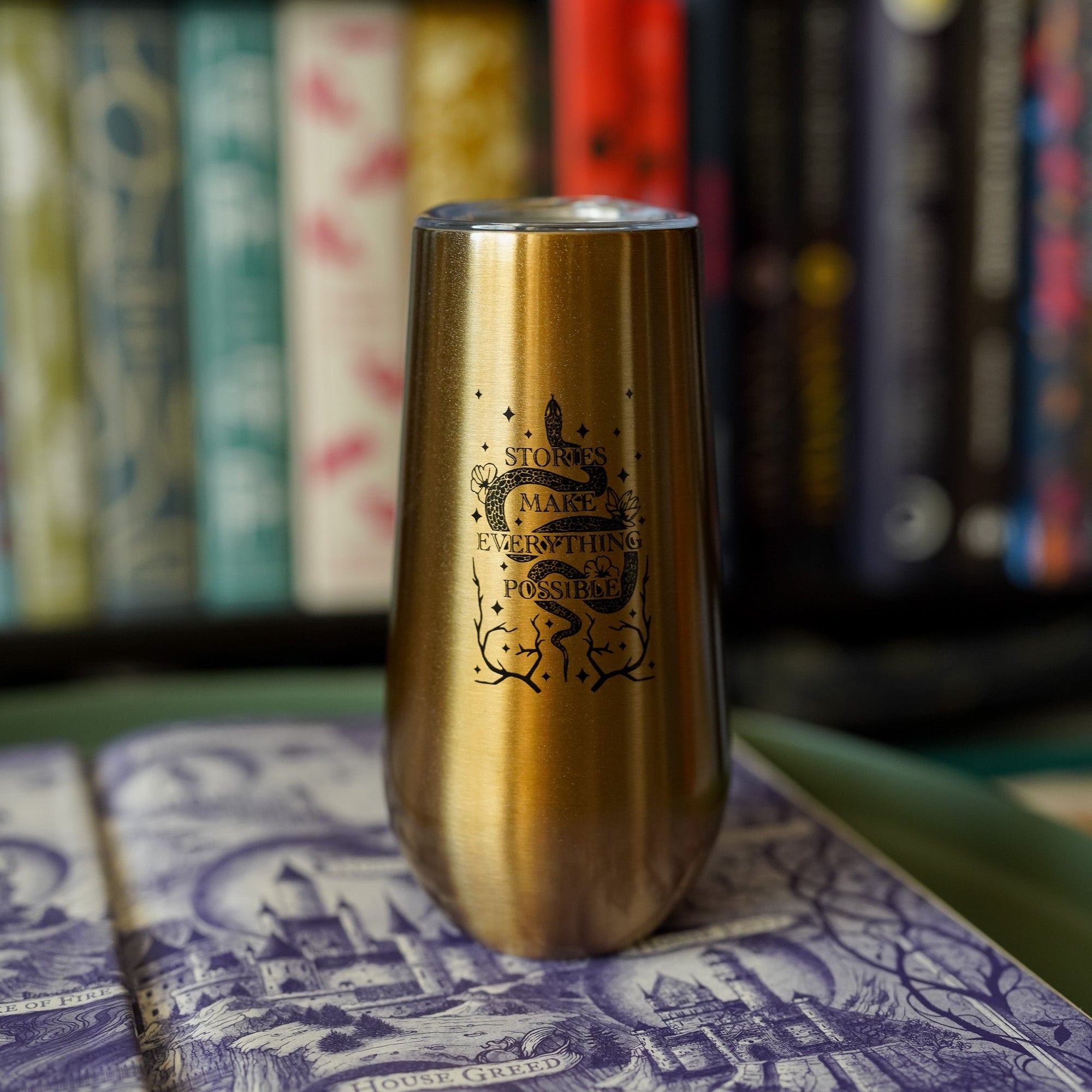 Kingdom of the Wicked Inspired Tumbler is gold with a black snake and the quote "Stories Makes Everything Possible"