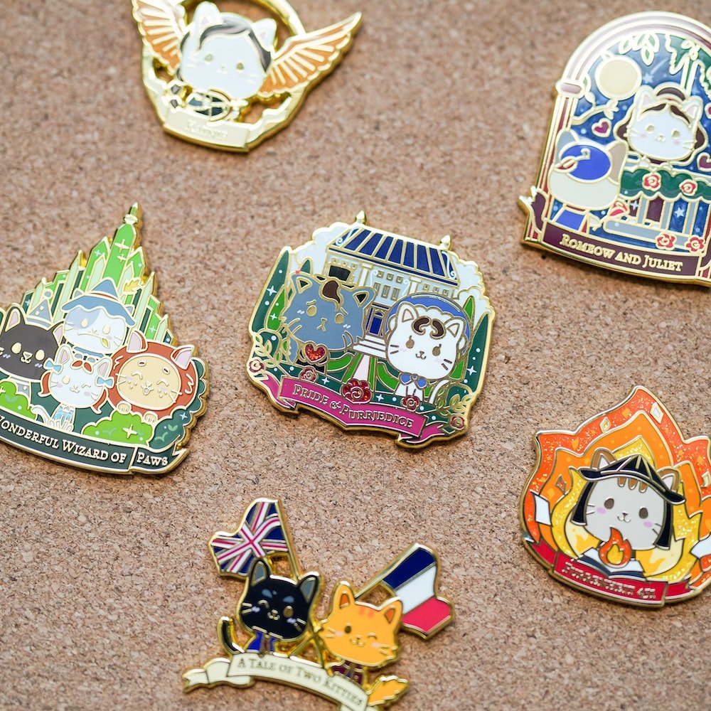 Literary Cats Blind Bag Enamel Pins displaying cats as different characters from literature