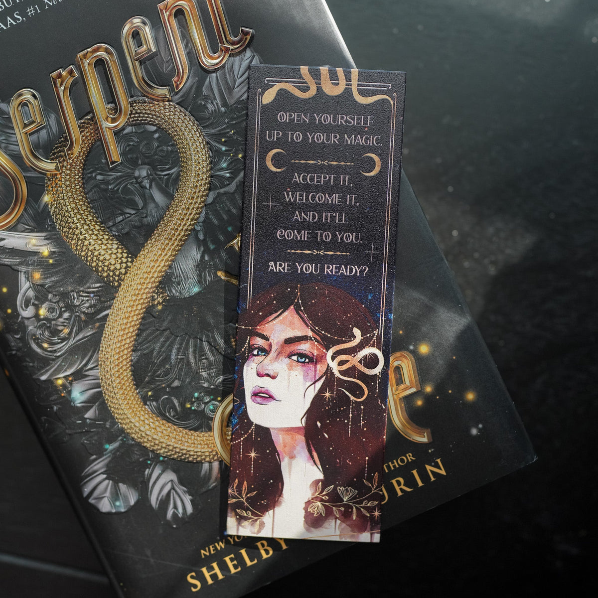 Magic Awakens Crate includes a bookmark of Lou from Serpent &amp; Dove and the words &quot;Open yourself up to magic. Accept it. Welcome it. And it&#39;ll come to you. Are you ready?&quot; 