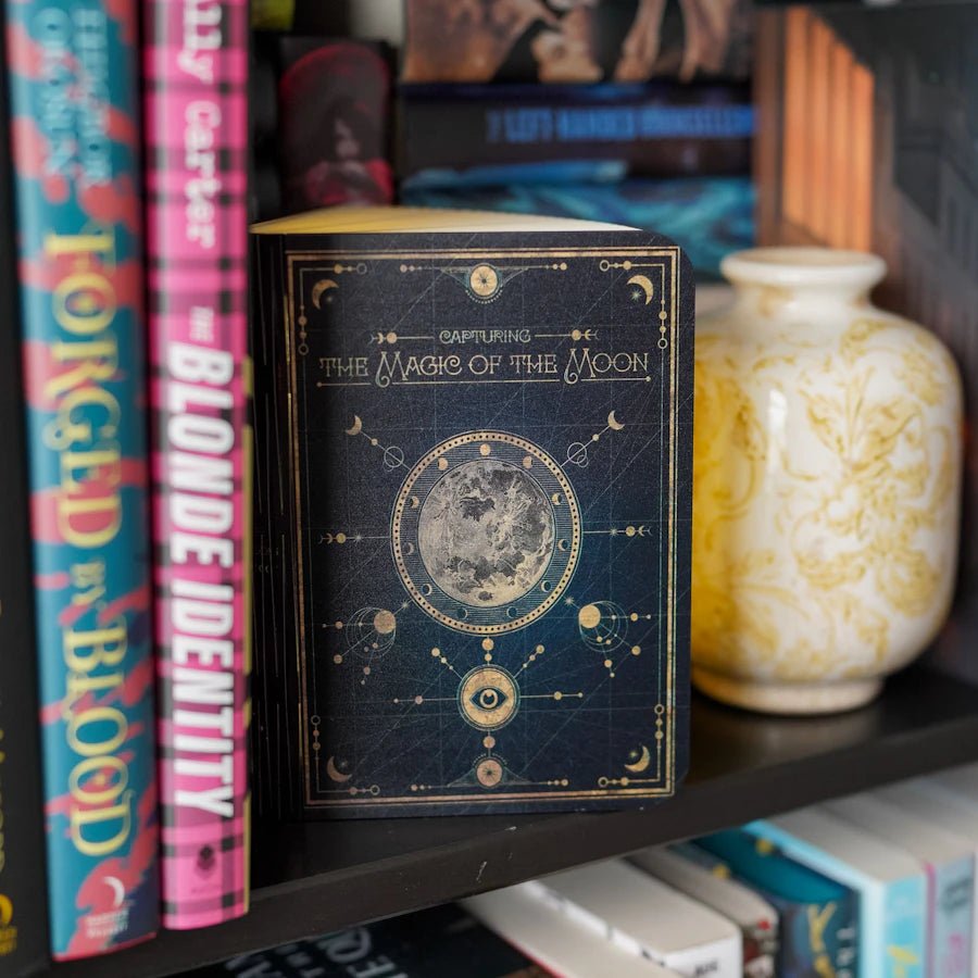 A book with moon cycle art and titled Capturing the Magic of the Moon opens to reveal a rechargeable LED light.