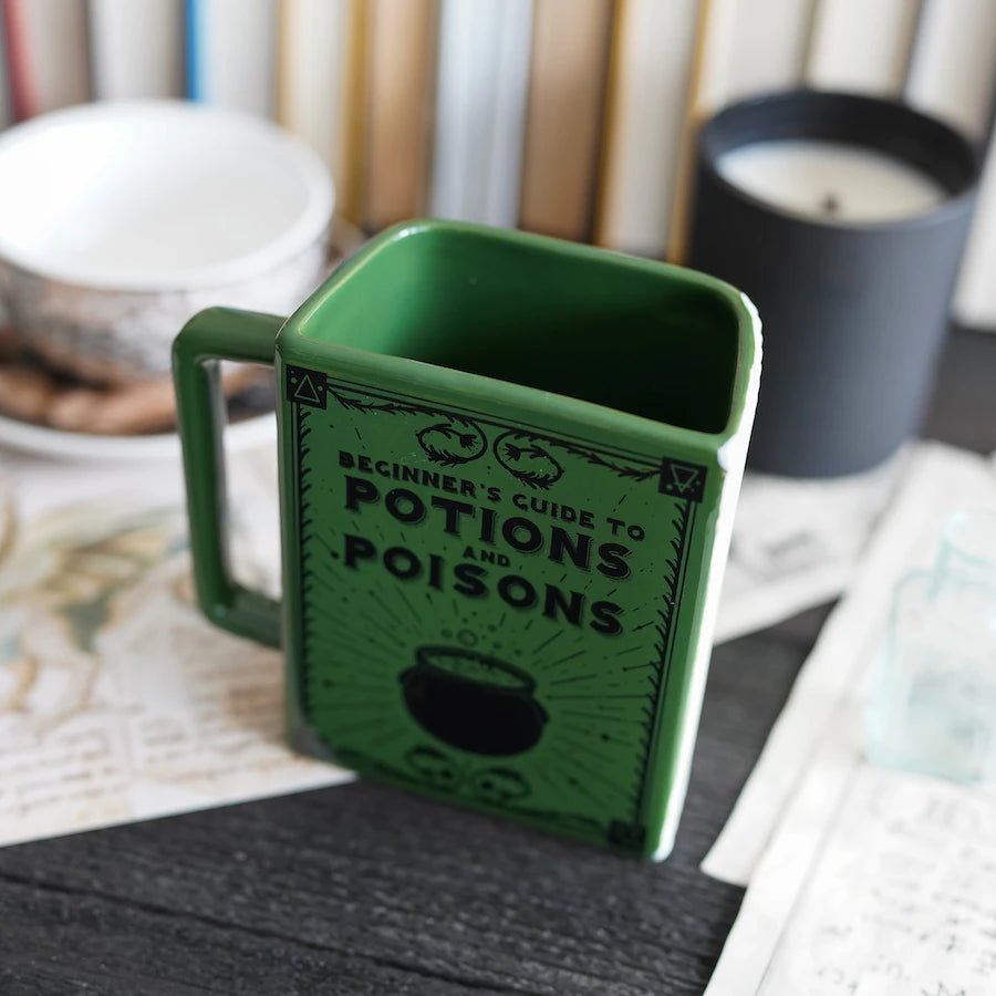 Beginner&#39;s Guide to Potions and Poisons Book Mug with a bubbling cauldron