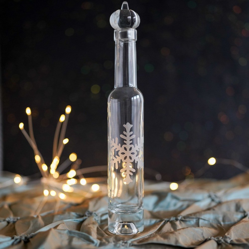 Pumpkin Punch Bottle with a glass pumpkin topper and snowflake design on exterior.