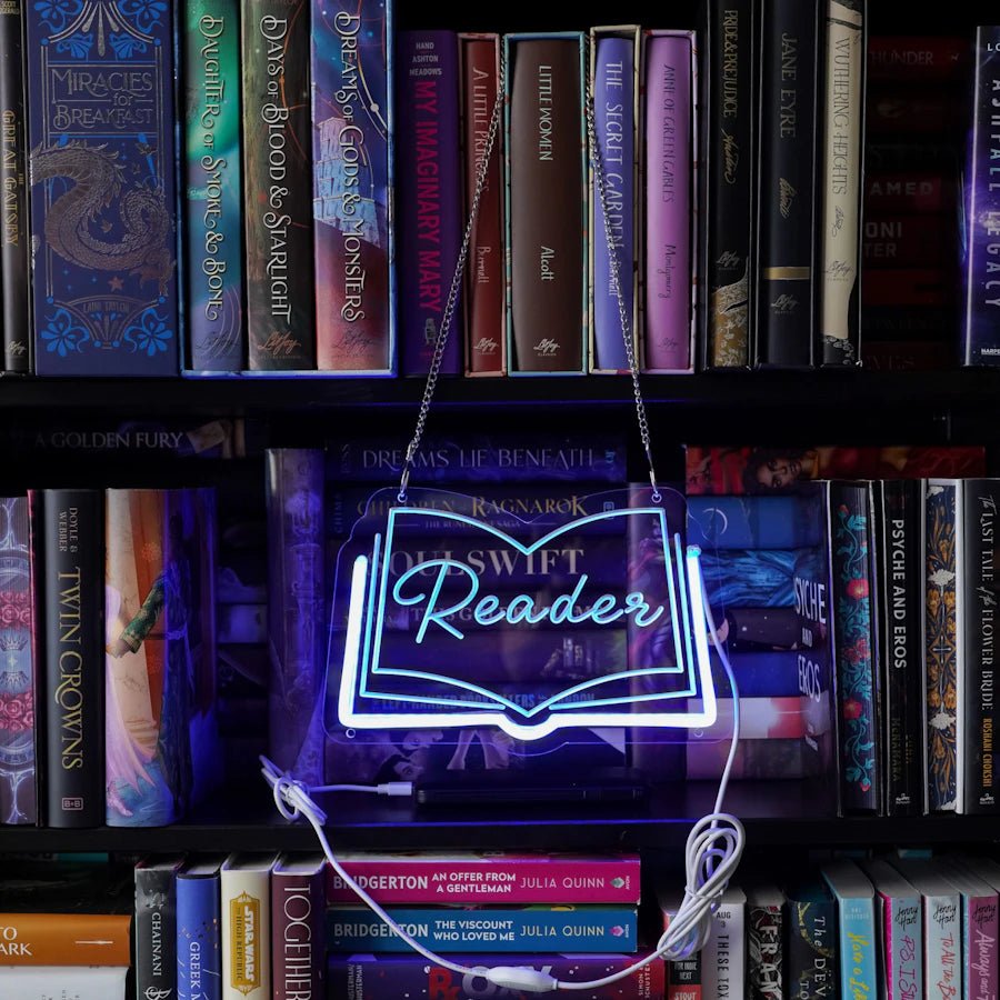 An open-book shaped LED light with the word reader in the middle, a blue LED light lines the sides and bottom giving a blue glow and appearing like a neon sign