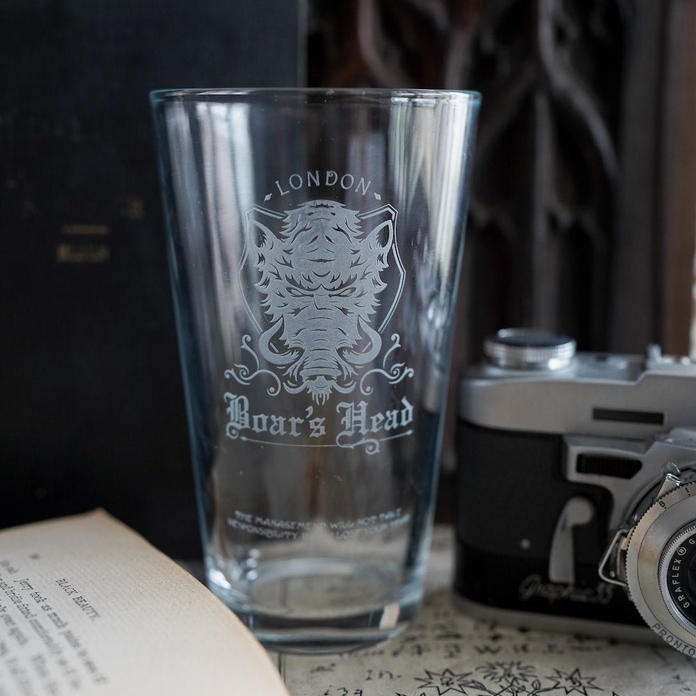 Shakespeare Boar&#39;s Head Pub Glass is a tall and clear cup with an etched boar&#39;s head and the words &quot;London&quot; and &quot;Boar&#39;s Head&quot;