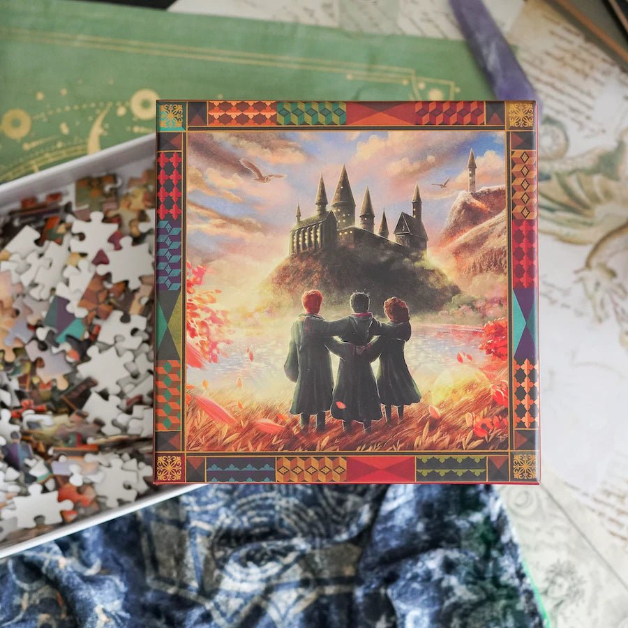 Take Me Home Theme Art Puzzle with an image of three wizard friends gazing at the wizard school castle and grounds with a snowy owl flying overhead.