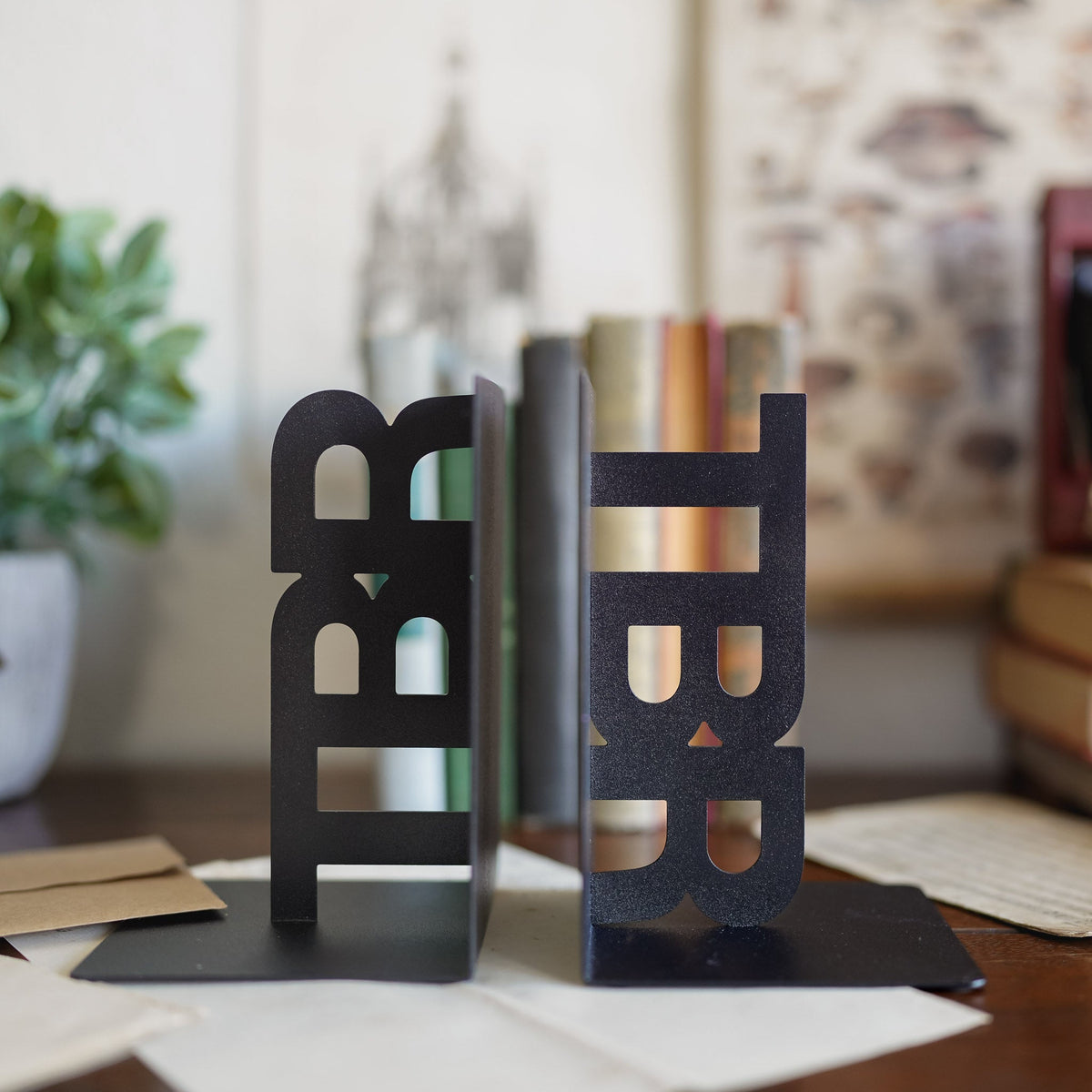 Black TBR bookends with &quot;TBR&quot; in block letters sitting on their sides