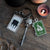 The Cracked Kettle Pub Key with a cauldron head, hinged libation menu charm, and a hanging sign charm.