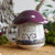 Purple and ivory The Cruel Prince Mushroom Mug with a handle, woodland artwork, and a mushroom cap top.