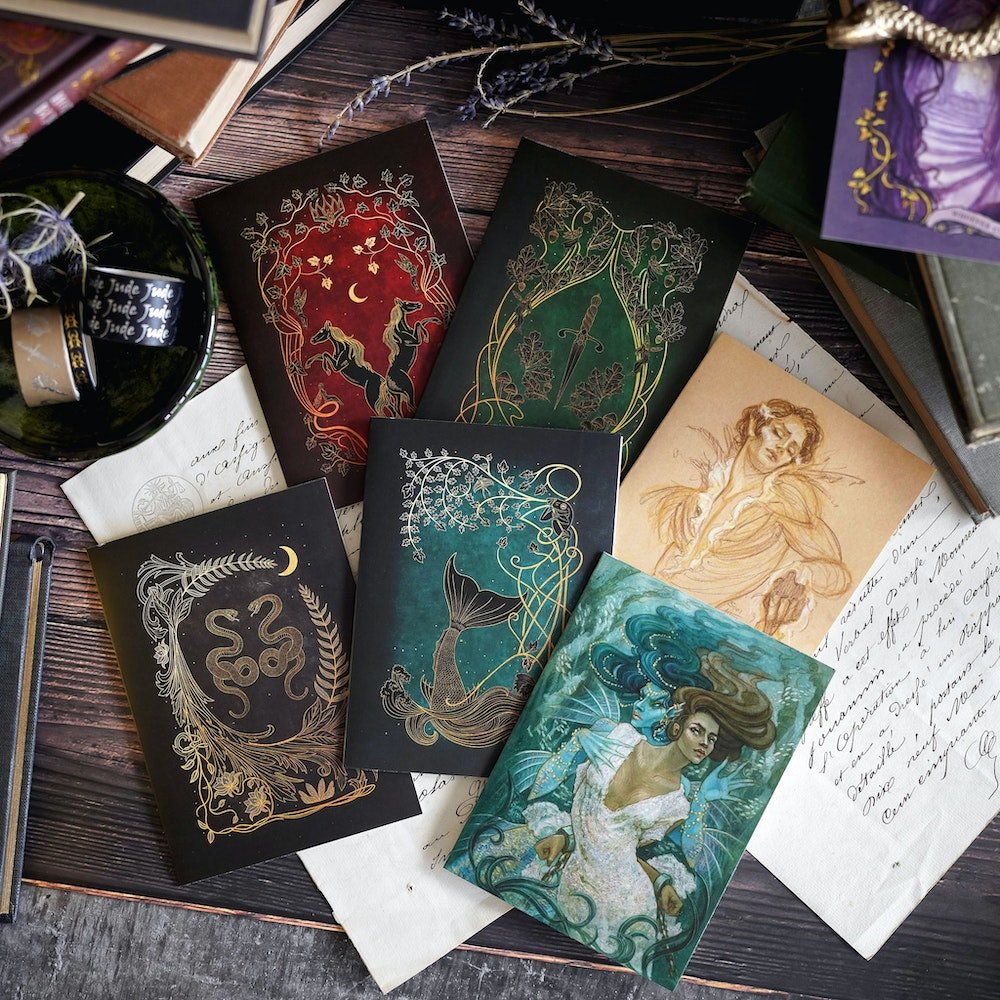 The Cruel Prince Stationary with magical images displaying a dagger, horses, snakes, mermaids, and characters from the book.