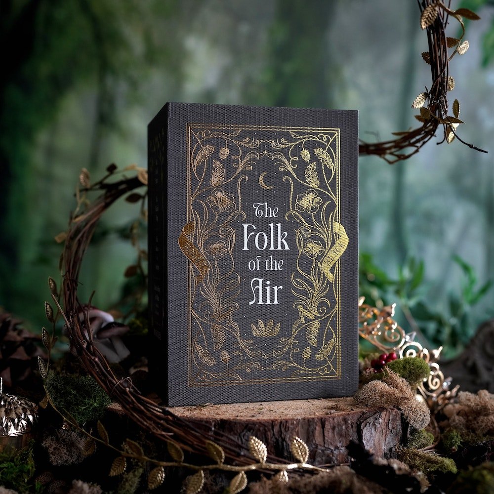 The Folk of the Air Box Set from LitJoy Crate is dark brown with gold foiling of leaves and flowers. It&#39;s surrounded by a woodland theme.