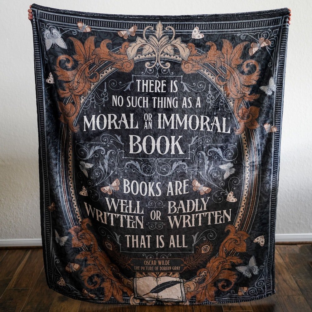 The Picture of Dorian Gray Blanket with a quote from the book printed on the front encircled by an oval frame featuring intricate gothic art and butterflies.