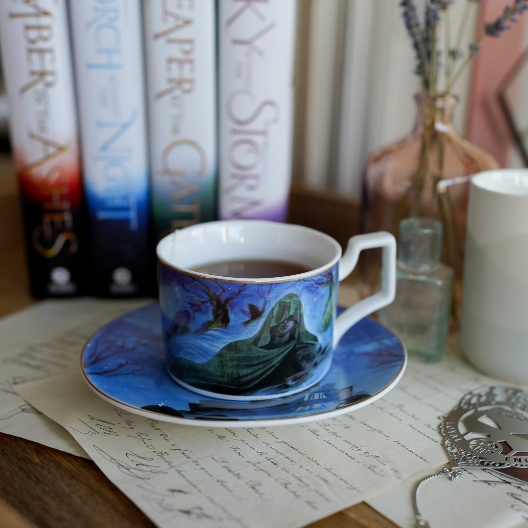 The Waiting Place Teacup and Saucer set has artwork of a hooded figure from An Ember in the Ashes