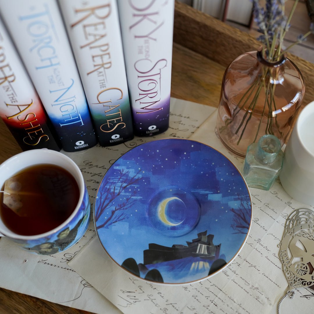 The Waiting Place Teacup and Saucer set has artwork of Laia and Elias from An Ember in the Ashes