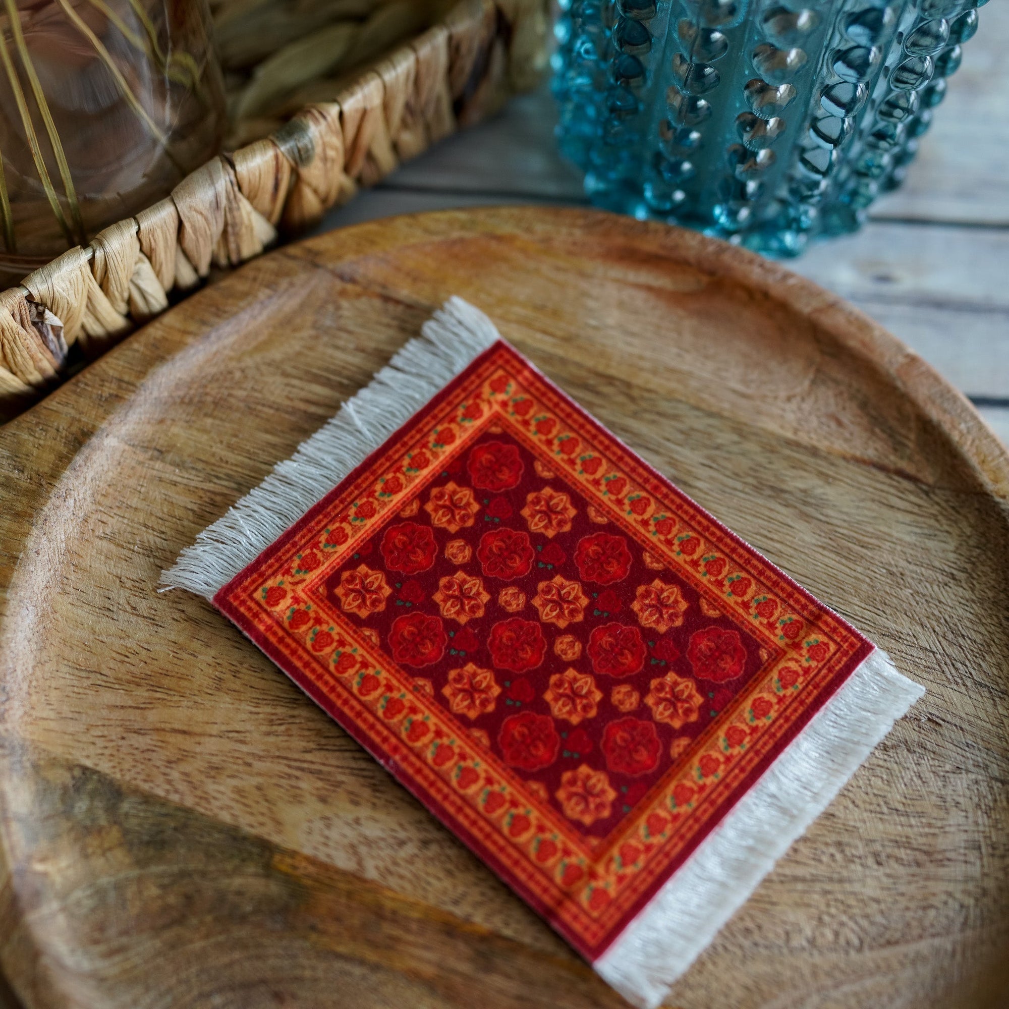 The Wrath and the Dawn Inspired Mug Rug has a red persian rug design and white fringe.