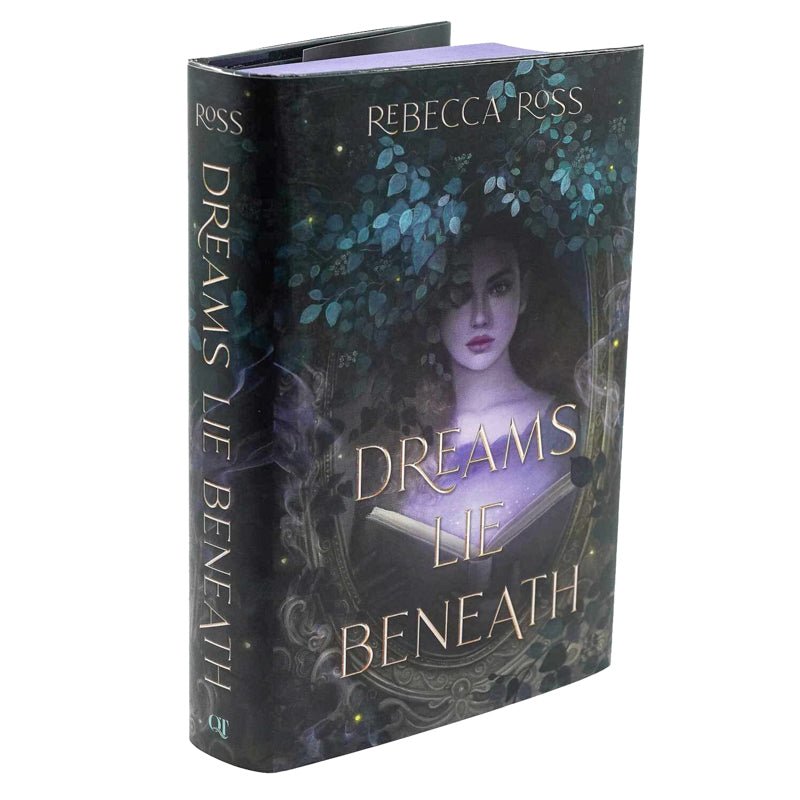 Dreams Lie Beneath book cover featuring character Clementine Madigan behind a mirror and brambles holding open a glowing book